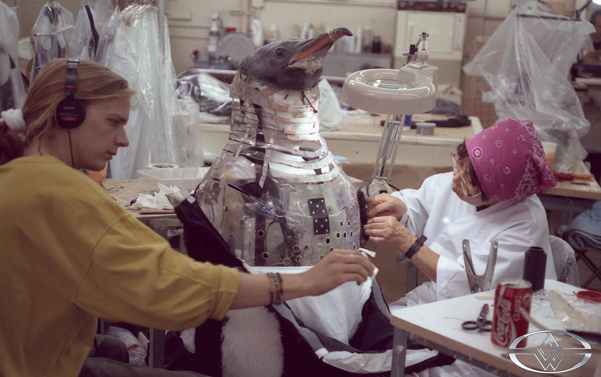 SWS artists Len Burge and Michiko Tagawa attach the outer fur to a penguin suit.