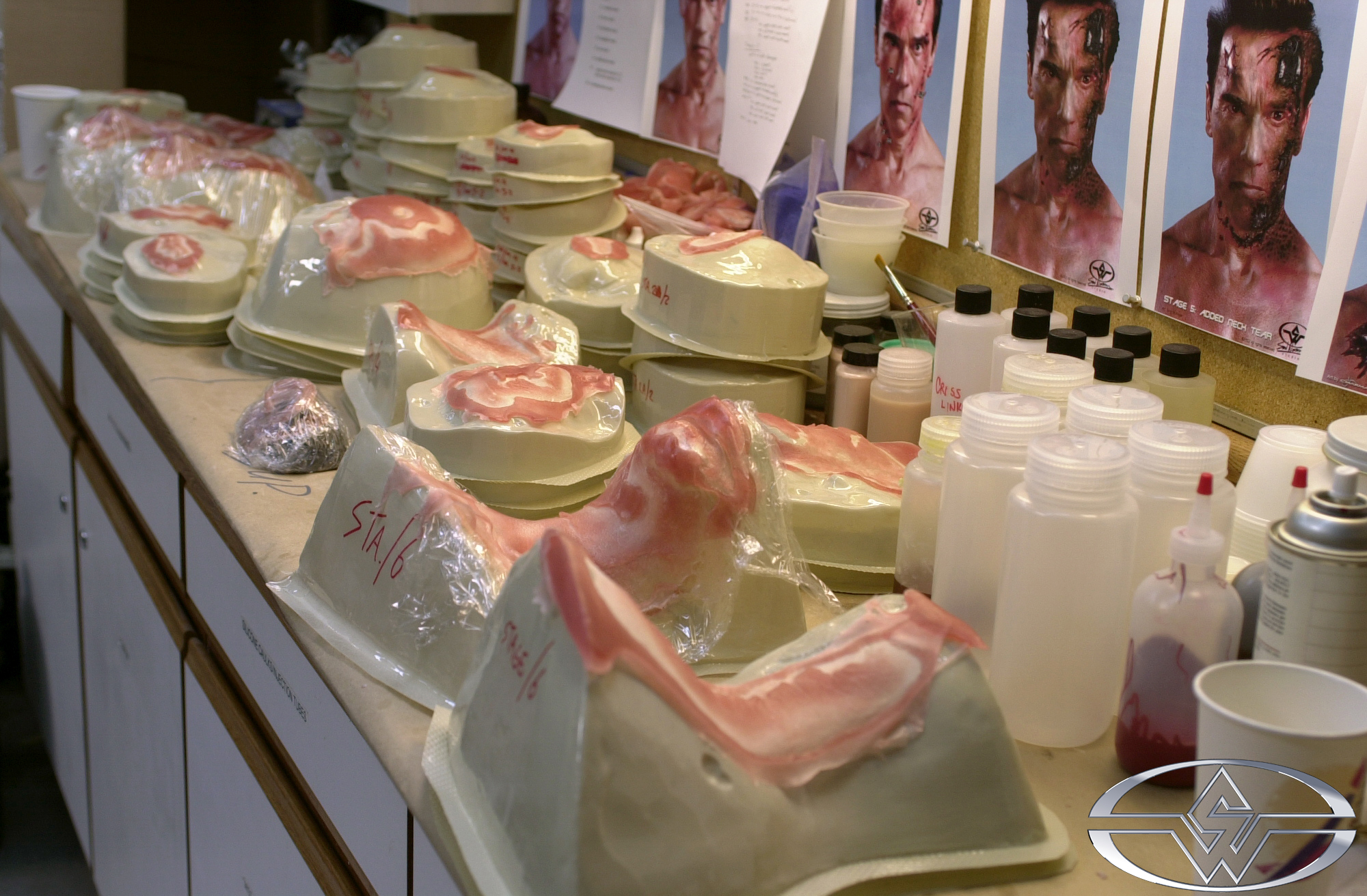 A variety of Terminator deterioration prosthetics on vacuum formed bucks are ready for painting and application.