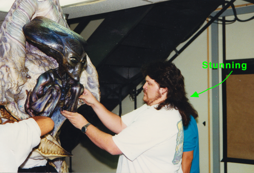 Gino working with the smaller Independence Day&nbsp;alien painted with pearlescent colors.&nbsp;That's&nbsp;Gino's notation about his 'stunning' mullet! Image source Tatopoulos Studios/TriStar Pictures