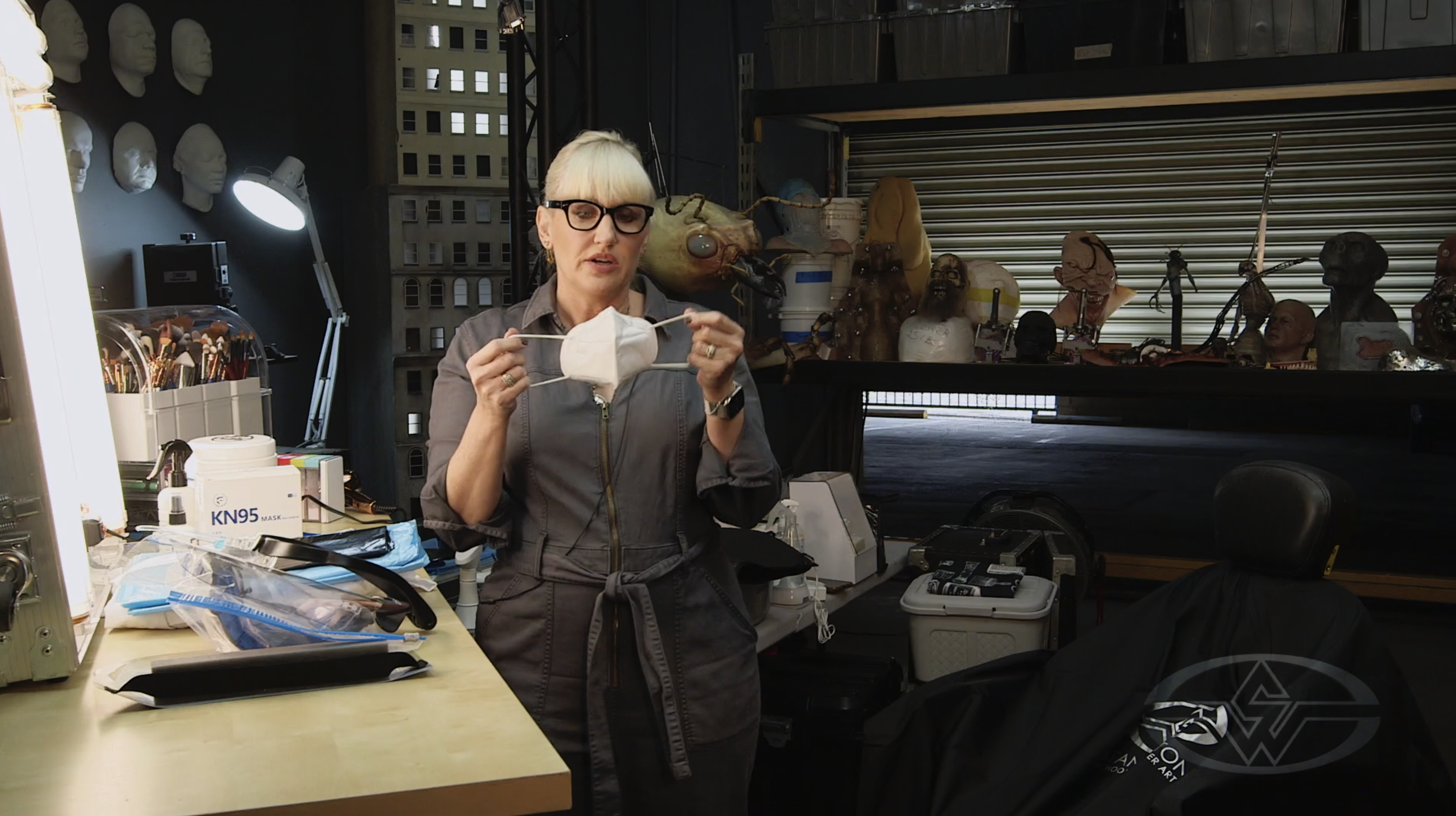 Eryn Krueger Mekash demonstrates the proper way to don a KN95 medical mask.