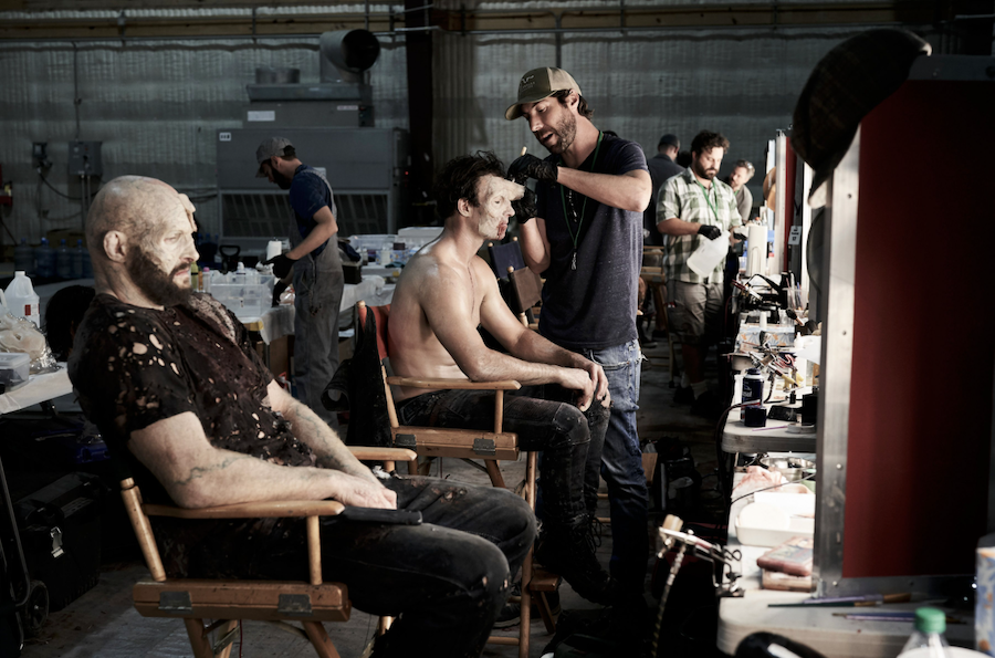 Makeup artists Jerrad Gray, Jon Shroyer, and Brian Perkal apply prosthetics to mid-background zombies.  Image courtesy Fractured FX/Netflix.