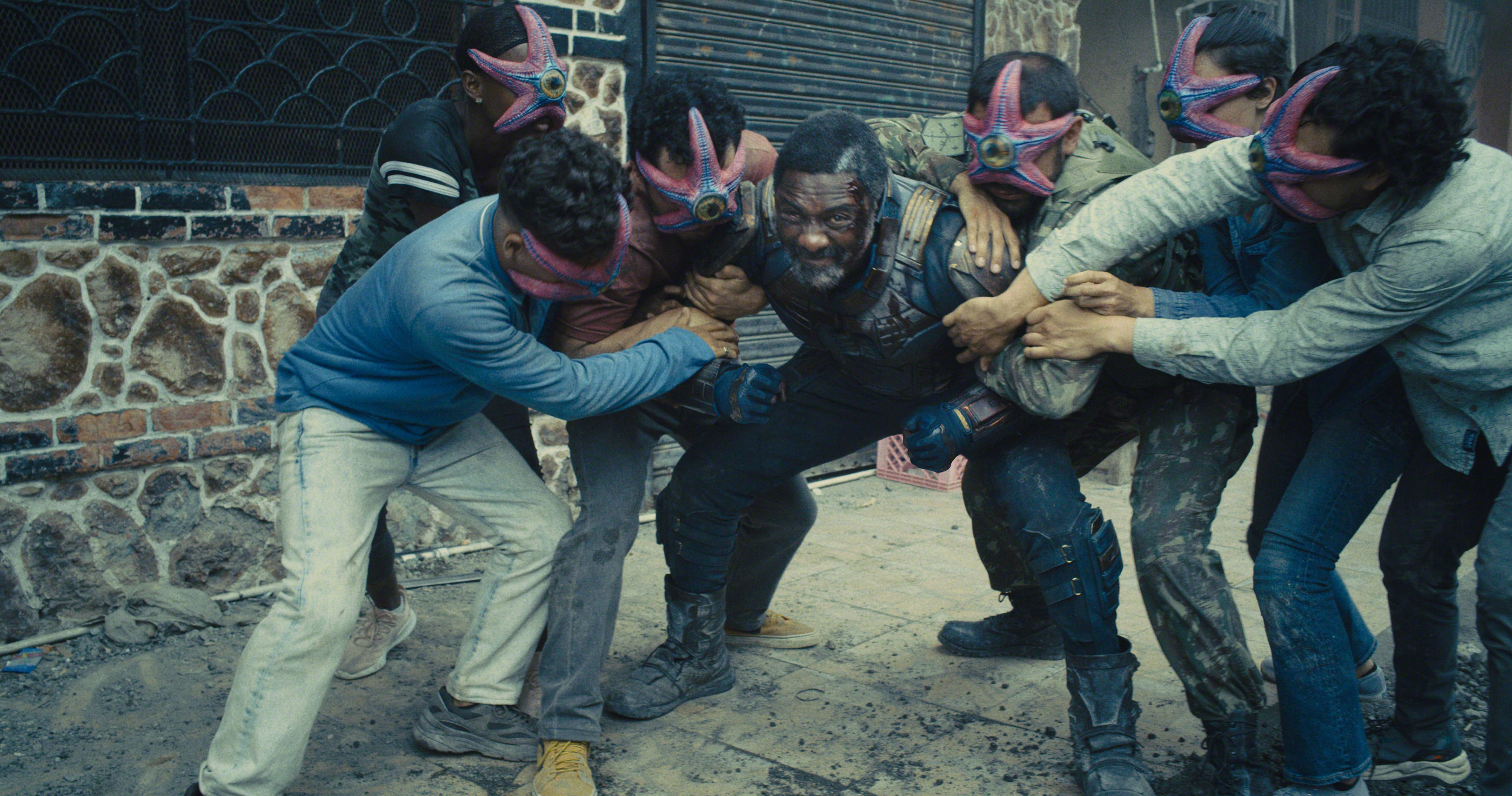 Bloodsport, played by Idris Elba, being attacked by Starfish-masked minions on the island of Corto Maltese. Image courtesy Warner Bros.