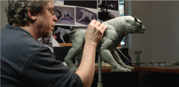 Steve Koch sculpting the Terror Dog maquette. Image courtesy Arjen/Sony Pictures.)