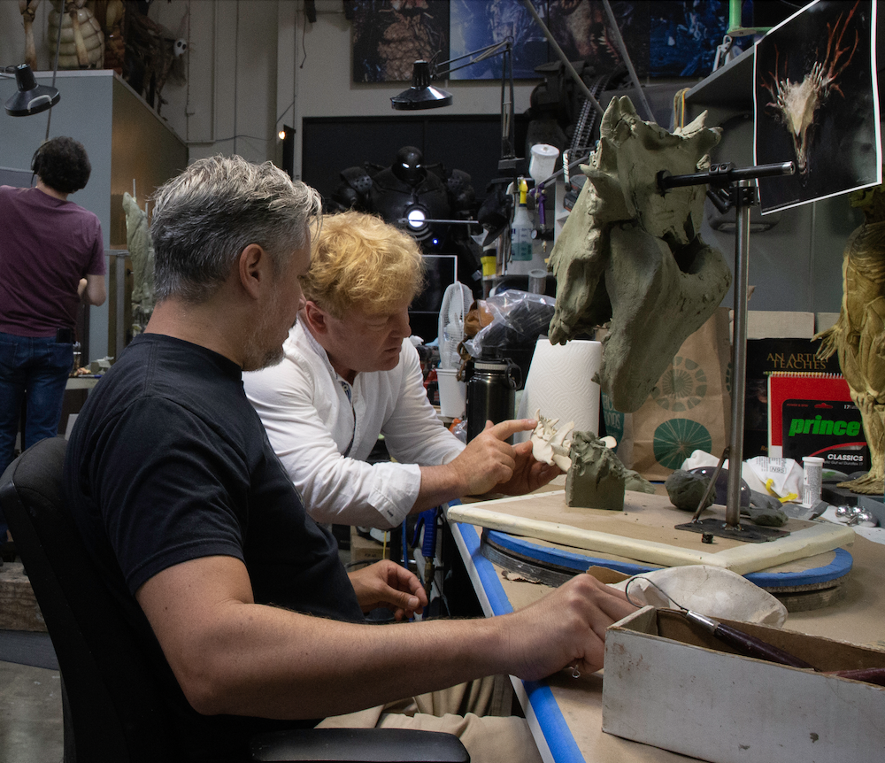 Shane Mahan and Jason Matthews discuss the Wendigo's teeth. Image courtesy Legacy Effects/Fox Searchlight.