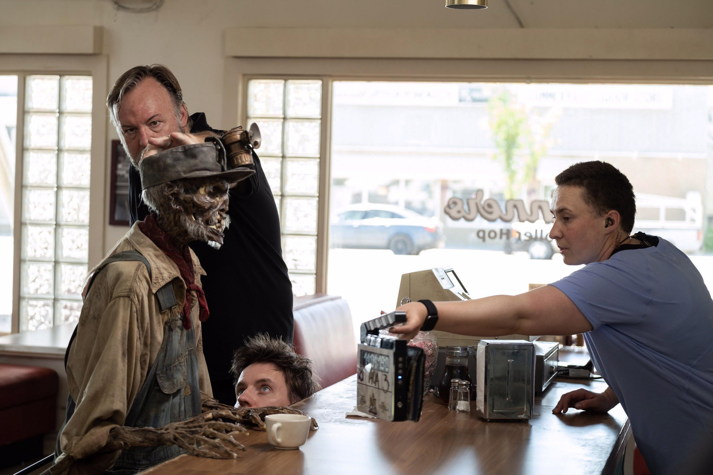 Arjen, Richard Landon and Ron Binion hidden puppeteer the Ghost Miner on the diner set. Image courtesy Sony Pictures.