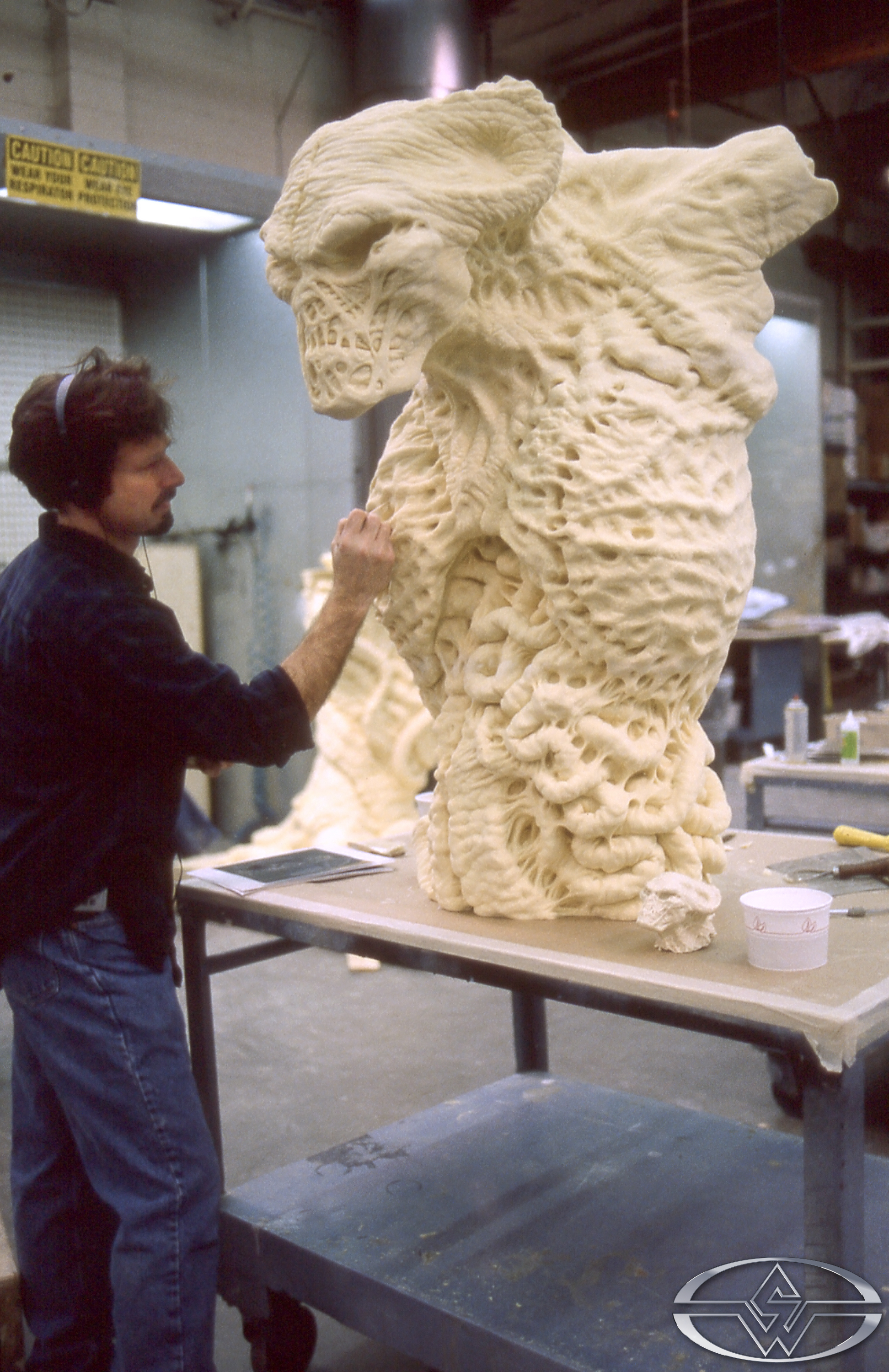 John Rosengrant adds sculptural detail to the computer-milled foam Satan beast form.