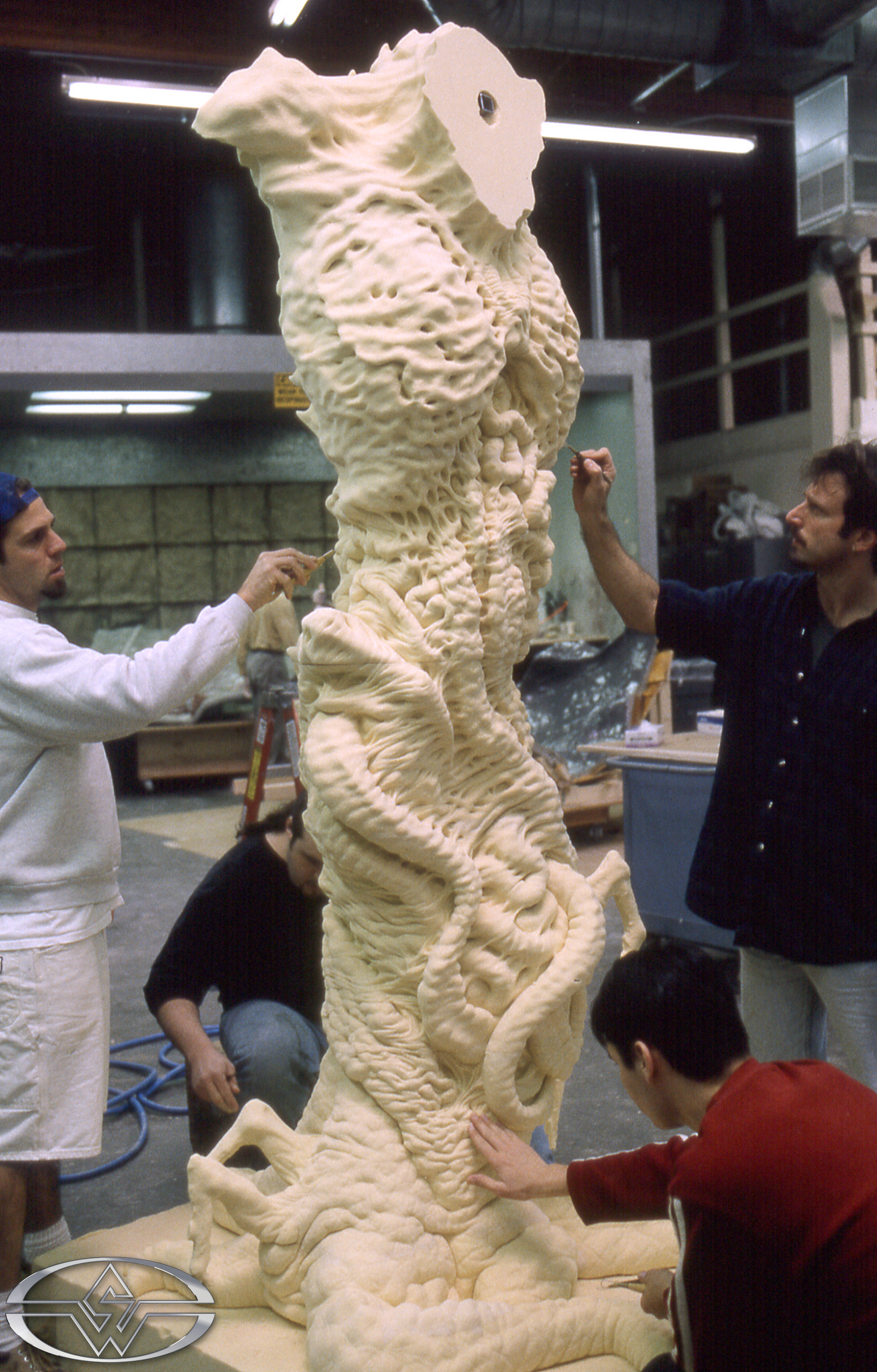 Stan Winston Studio crew members [clockwise from top left] Rob Ramsdell, John Rosengrant, Jason Matthews and Trevor Hensley detail the computer-milled foam Satan beast body.