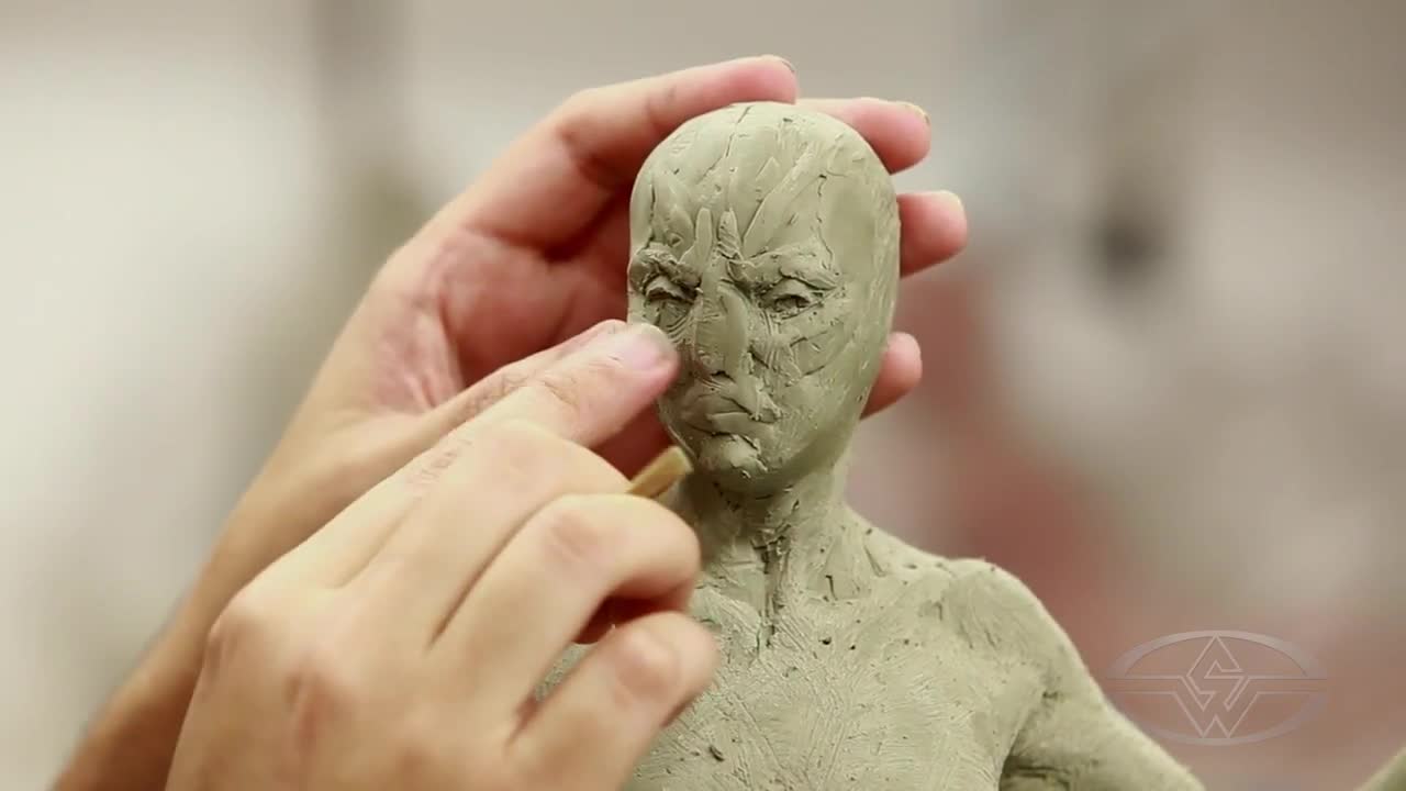 Alfred Paredes uses finger and tool interchangeably to smooth his shapes.