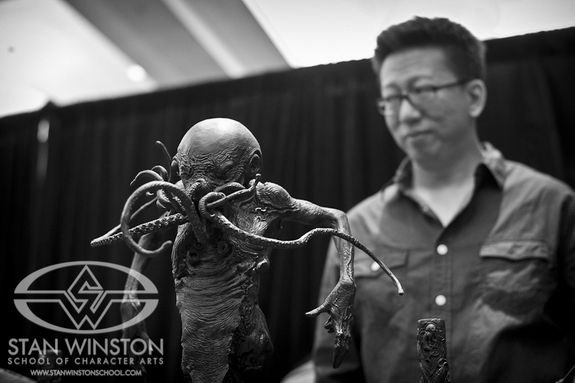Simon stands in the background with one of his sculpture maquettes inspired by HP Lovecraft's Elder God, Cthulhu.