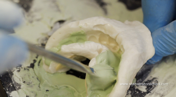 Mark Viniello uses a brush to poke the&nbsp;Die-Keen®&nbsp;into all the nooks and crannies in the alginate. The more information captured, the better.