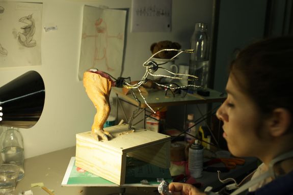 Lead fabricator Sara Gerstel fashions a toy Dinosaur leg around the simple wire and epoxy armature.