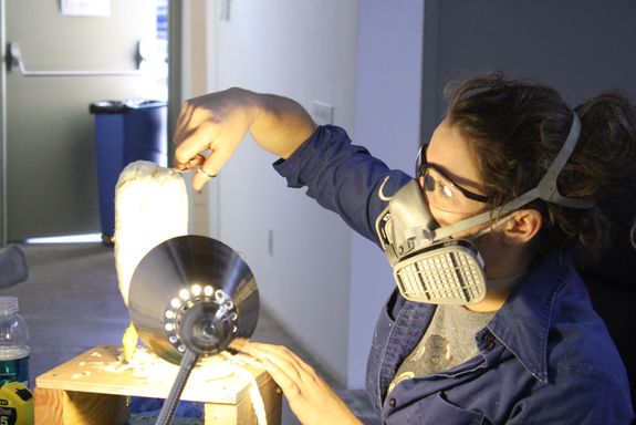 Sara shaping the Breadwich puppet while wearing the appropriate goggles and mask for protection.