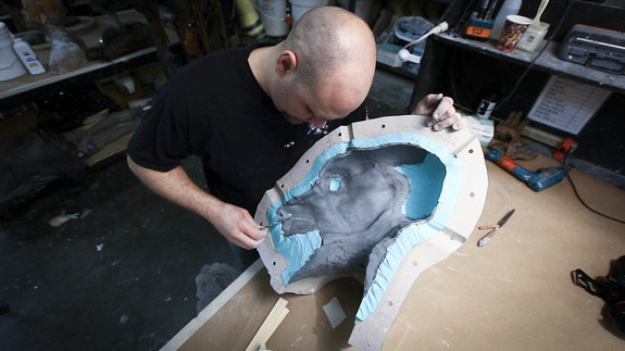 Tim lays a thickness of clay inside the Matrix mold to pour a test skin for Animatronics.