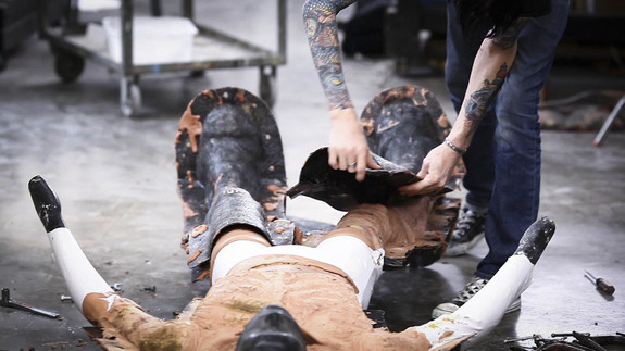 Chris Baer pulls the body mold apart to reveal the foam legs and body on the Lycra suit.
