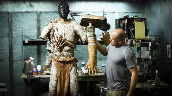 After the alterations, the sewing, and patching are complete, Tim Martin paints and adds mud texture and costume elements. The suit is ready to go to set for the test shoot.