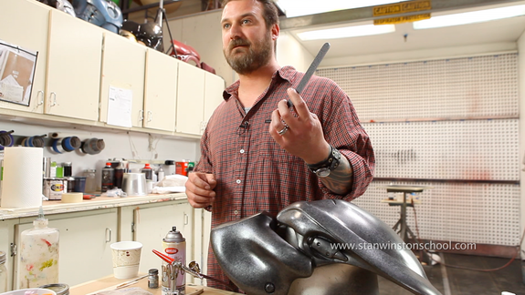 Master creature, robot, and Iron Man painter, Jamie S. Grove, displays one of his secret weapons.