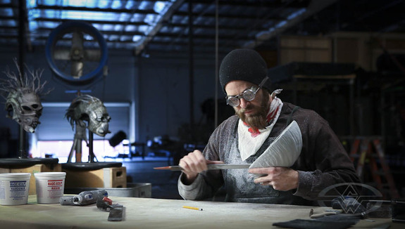 Bruce D. Mitchell uses a heavy rasp to cut detail and shape in his latest piece of dynamic wearable art.