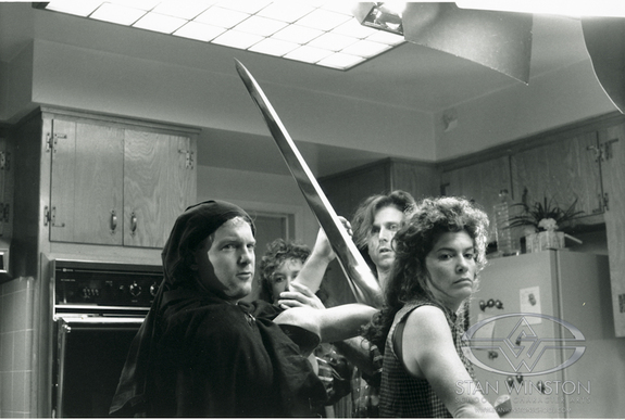 Shane Mahan (in black cowl) prepares to puppeteer the T-1000 blade arm in Terminator 2: Judgment Day.