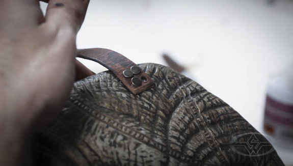 Aging the leather with acrylic paint and using pre-aged rivets assures a well-worn, timeless look for the entire piece.