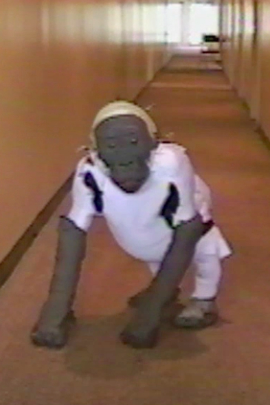 Actor Verne Troyer tests out the toddler gorilla arm extensions and muscle suit.