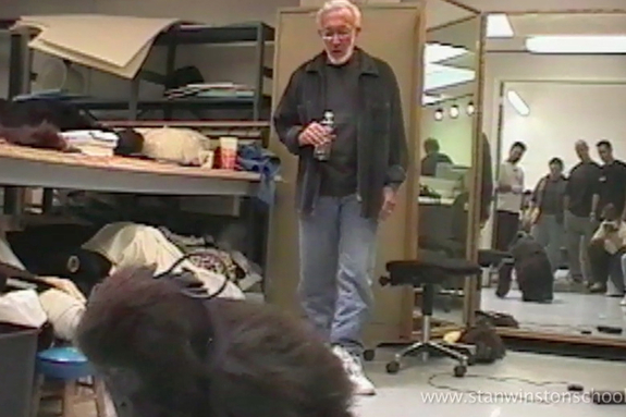 Stan Winston and crew watch Verne Troyer put their gorilla suit through its paces.