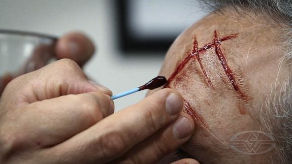 Christien paints in the deeper blood.