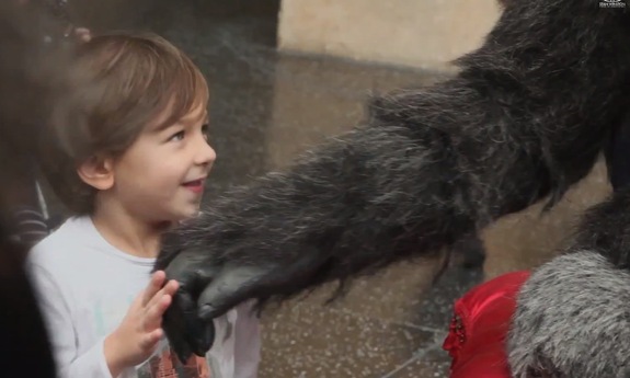 ADI's Connor Woodruff, Dave Penikas, and Garth Winkless bring Santa Gorilla to life to the delight of a young child.