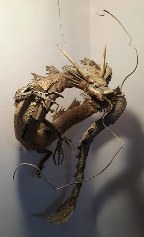 A cardboard horse and a cardboard dragon. The dragon was Xhongkai's first creation, and it remains his favorite piece.