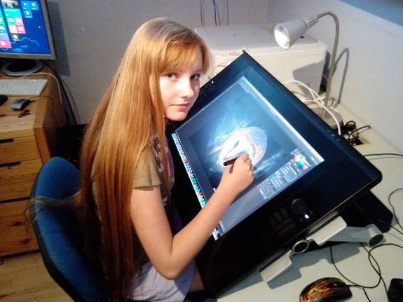 Emka Klučovská works on a portrait of an owl using her digital drawing table.