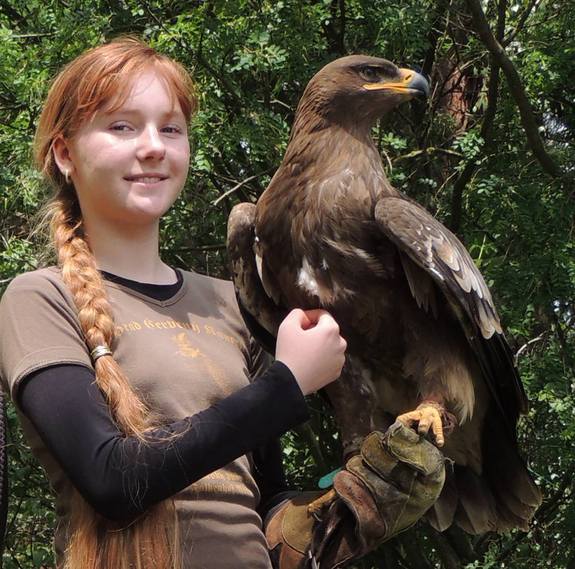 Emka poses with her falcon. Her love of birds was the early inspiration for her drawings.