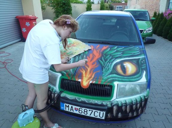 Emka's talent knows no bounds; here, she decorates the family car.