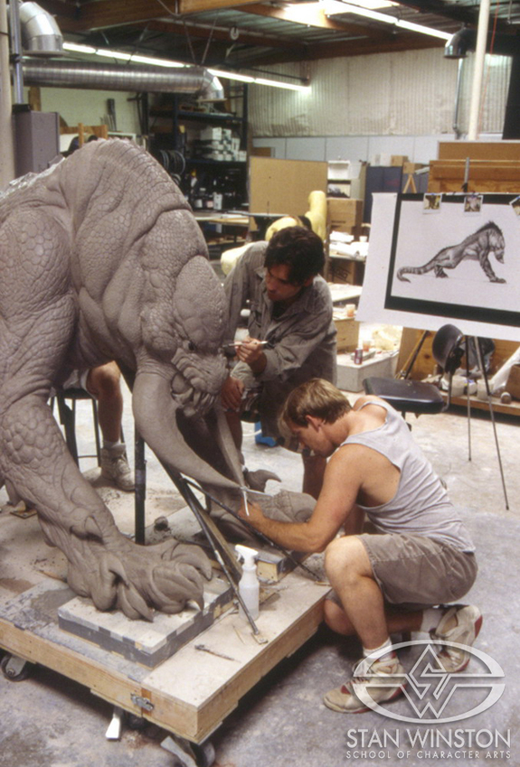 Christopher Swift and Mark Crash McCreery add details to the full-size Kothoga sculpture. Because of the limited pre-production time, water-based clay was used for creating the sculpture.