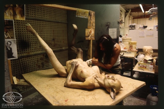Joey Orosco airbrushes the beast-woman, which would later be mechanized on the fly for the scene where she gives birth to a mutant baby.