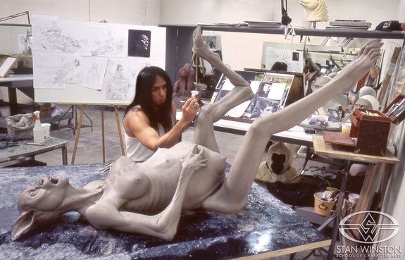 Joey Orosco at work on the pregnant beast-woman sculpture.