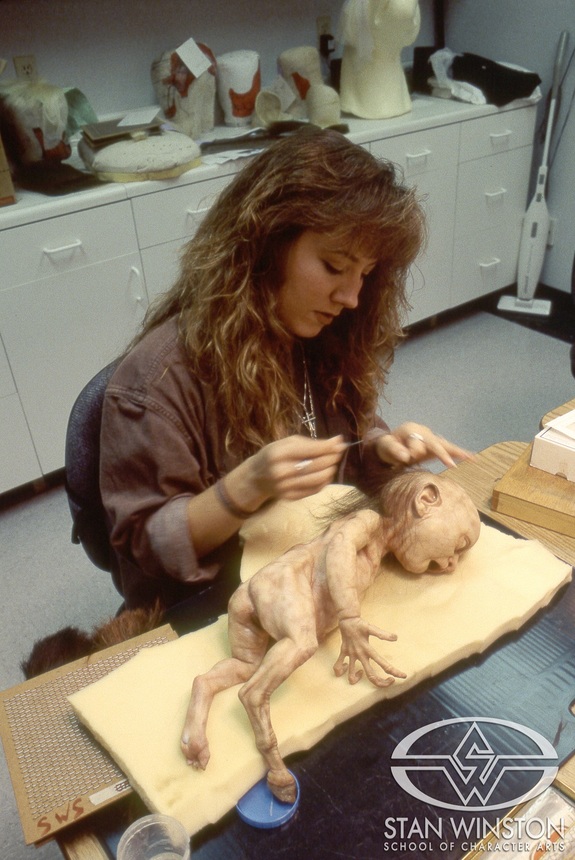 Ursula Ward punches hair into the mutant baby at Stan Winston Studio.