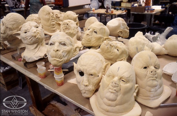A menagerie of beast-people masks ready for paint.