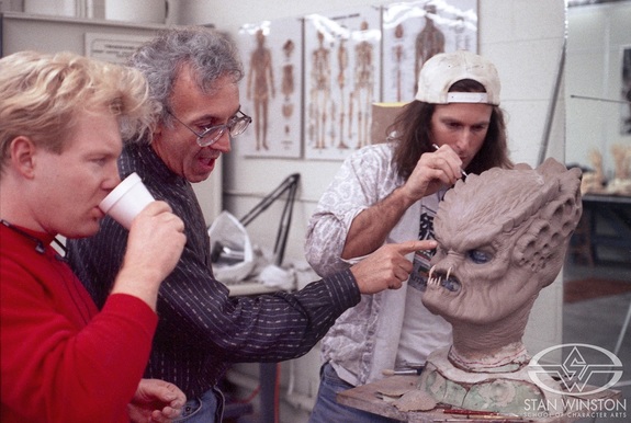 John Rosengrant sculpts the Predator stunt head as Stan Winston and Shane Mahan discuss brow detail.