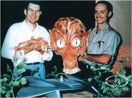 Bob Burns & Paul Blaisdell pose with a repainted mask from Invasion of the Saucer-Men&nbsp;and a flying saucer they built together.