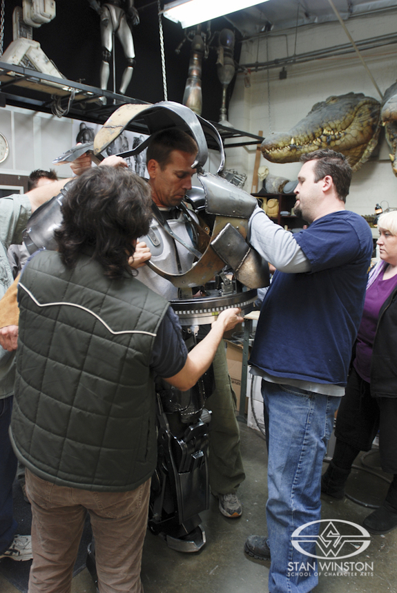 Christopher Swift, Trevor Hensley, and Tamara Carlson Woodard seat the Mark I upper torso onto the aluminum "lazy susan" support ring.