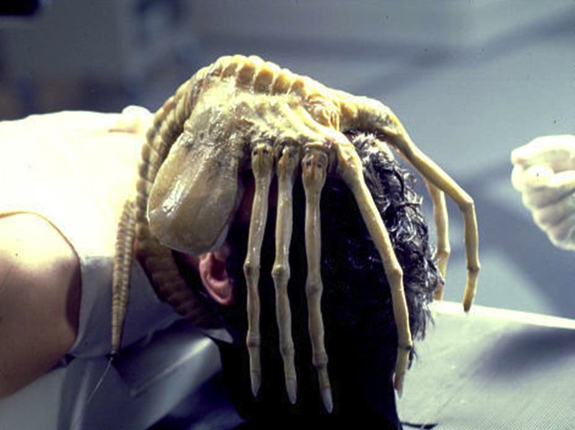 An Alien facehugger implants the unsuspecting Kane (John Hurt) with a xenomorph baby.