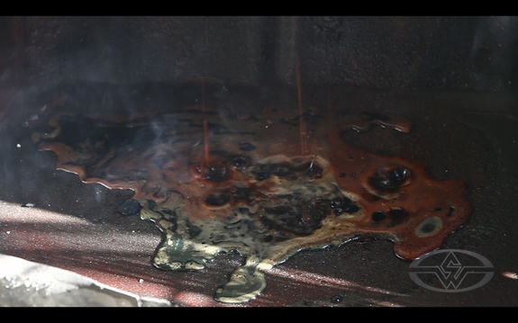 (They don't call it “Lost Wax” for nothing. Enrique holds fire to the shell until all the wax is burnt out.