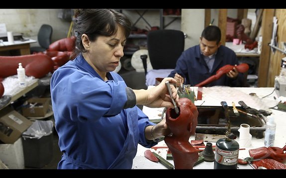 AFAF's Herminia 'chases' the details and imperfections in the wax. She then cuts vents and adds wax rods, which will later create paths for the bronze to flow through, a process known as 'gating.'