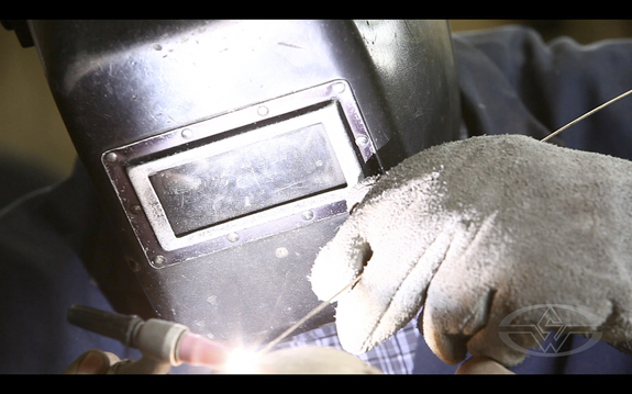 AFAF's Servando tack welds the bust back together. The weld seams will then be removed.