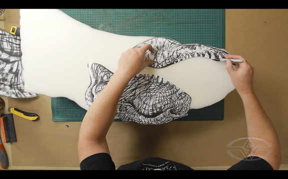 Top: A T-Rex design in Photoshop. Bottom: Ted Haines outlines the features of the T-Rex’s face onto the foam.